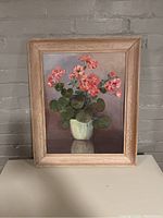 Full view of the framed flower painting showing the entire artwork and wooden frame.
