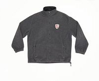 Front view of vintage dark grey Roots full zip fleece jacket laid flat, showing embroidered crest logo on left chest and zippered front pockets.