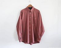 Full front view of the Tommy Hilfiger plaid button down shirt hung on a hanger showing the overall pattern and condition.