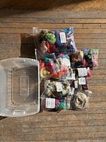 Plastic storage bin with assorted sealed fiber packs arranged inside and beside it