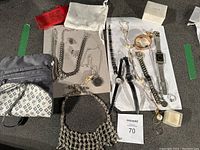 Full overview of all jewelry, watches, scarves, bags, and boxes in lot.
