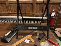 Overview of Black & Decker portable project center with vice, hand saw, putty knife, paint roller, and tile cutter near the left side.