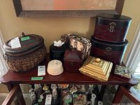 Photo of all decorative and keepsake boxes on wooden table showing variety of styles and materials.