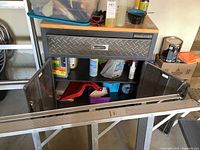 Front view of Mastercraft rolling tool cabinet showing open lower cabinet doors revealing some contents inside. Drawer is closed.