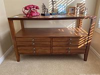 Front-facing view of console table with decorative items on top.