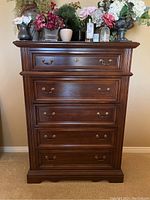 Front view of five-drawer dresser showing drawer fronts and hardware.