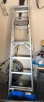 Front view of 6ft aluminum ladder with metal steps