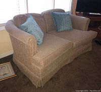 Front perspective of loveseat with two seat and two back cushions