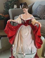 Front view of the Royal Doulton figurine showing details of the dress and facial features.