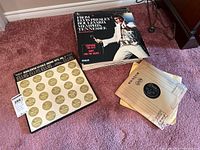 Top-down image of vintage Elvis Presley LP records including 'From Elvis Presley Boulevard, Memphis Tennessee' and 'Worldwide 50 Gold Award Hits, Vol. 1' plus some loose records with paper sleeves.
