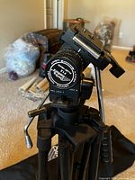 Close-up front view of the F12 fluid head showing adjustment dials and pan lock.