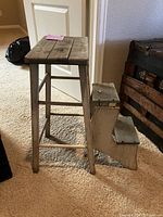 Antique convertible wood stepladder with wooden bench top and side steps, showing rustic aged wood and foldable design.