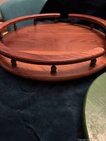 Close-up of the large oak lazy susan showing the wooden spindles and the raised edge design.