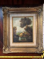 Frontal image of the small oil painting in a large ornate gold frame showing the full artwork and frame.