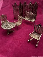 All six pieces arranged on red backdrop