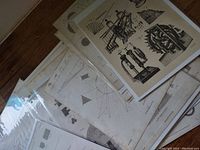 Stack of antique mechanical and scientific diagrams showing various 19th century devices and geometric figures.
