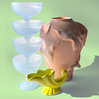 Photo of pink shell vase with embossed shell designs, green shell vase in yellow-green ceramic, and four frosted opaline glass goblets stacked.