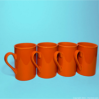 Four pumpkin orange ceramic mugs side by side, showing color and shape.