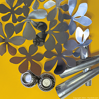 Close-up of stainless steel floral bowl showing flower cut-out design