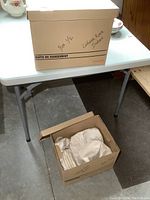 Two boxes labeled 'Cottage Rose Dishes' containing packed china pieces.