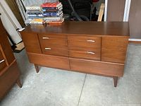 Front view of dresser showing six drawers and metal handles