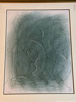 Frontal view of framed artwork showing abstract pastel drawing of two overlapping female figures on green background