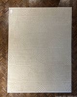 Full top-down view of rug on wood parquet floor