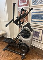 Full side view showing the step trainer’s frame, pedals and handles