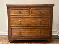 Front elevation view of dresser showing drawer layout and hardware