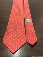 Full front and back of tie laid flat on surface