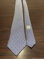 Full view of tie laid flat showing overall pattern and shape