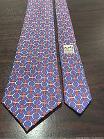 Full view of tie front side laid flat on dark surface