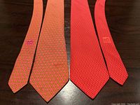 Both ties laid flat showing front blades and tails.