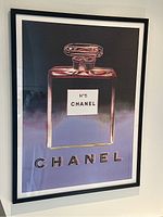 Frontal view of framed poster on wall showing entire artwork and frame