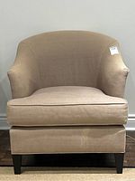 Front view of beige textured armchair showing overall design