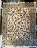 Full view of rug laid flat on hardwood floor showing overall pattern