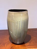 Front full view showing exterior sage color and vertical lines