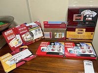 Several boxed official Canadian stamp collections displayed on a table, unopened and in good condition.