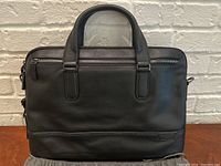 Front view of briefcase showing dual handles and zipper closure