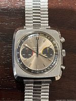 Front view of watch face showing silver dial, black subdials and case finish