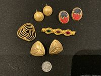 Photo showing the full set of vintage costume jewelry including earrings, ring, and brooch with a quarter for scale