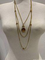 Vintage Goldette 3-strand gold tone necklace worn on a mannequin showing the layers and overall design.