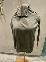 Light gray long-sleeve turtleneck displayed on a mannequin showing overall style and fit.
