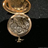 Back cover open showing full mechanical movement and interior lid engraving