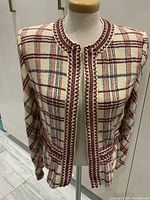 Front view of the vintage St.John by Marie Gray jacket showing the plaid pattern and red braided trim.