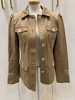 Front view of the tan Marc Jacobs jacket with button-up closure and four front pockets.