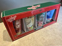 Original box containing four 16oz glasses themed around the movie A Christmas Story, showing character images and movie quotes.