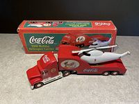 Photo showing Coca Cola 2000 Holiday Helicopter Carrier with original box in background.