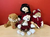 Five plush Christmas bears arranged with red background, showing variety of outfits and accessories, including hats, collars, and festive dresses.