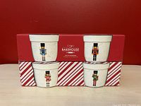 Set of four nutcracker-themed ceramic ramekins in original red and white striped packaging with Circa The Bakehouse branding.